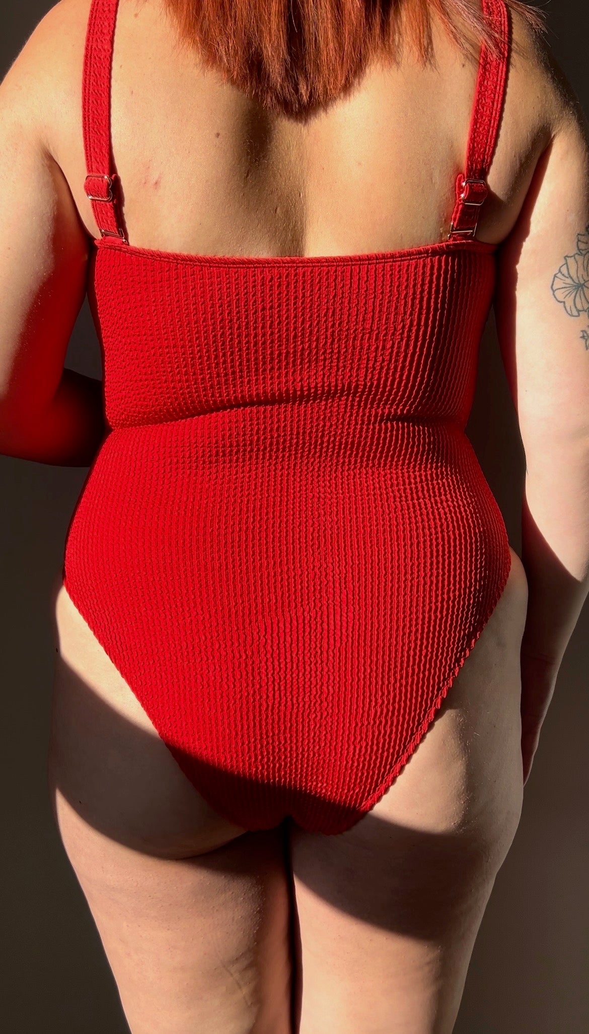 Red / chili one piece from the back close up. Model wears the square neck textured crinkle one piece, removable straps