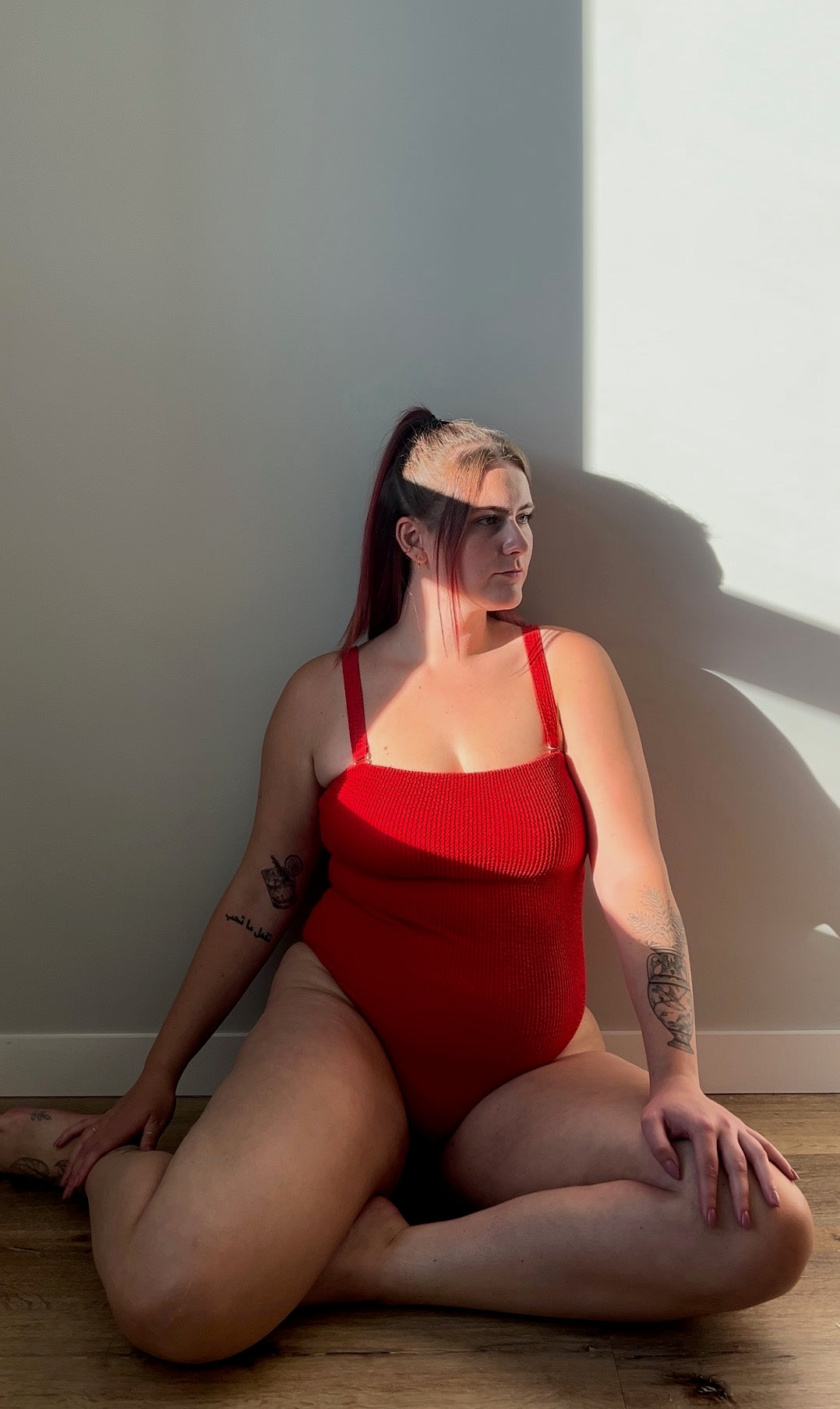 Red / chili one piece from the front. Model wears the square neck textured crinkle one piece