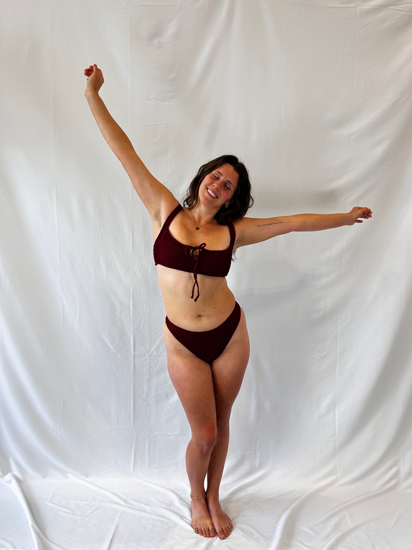 Burgundy two piece bikini. Bikini top is the milkmaid style tie front crinkle fabric. Bikini bottom is the high rise cheeky textured crinkle fabric.