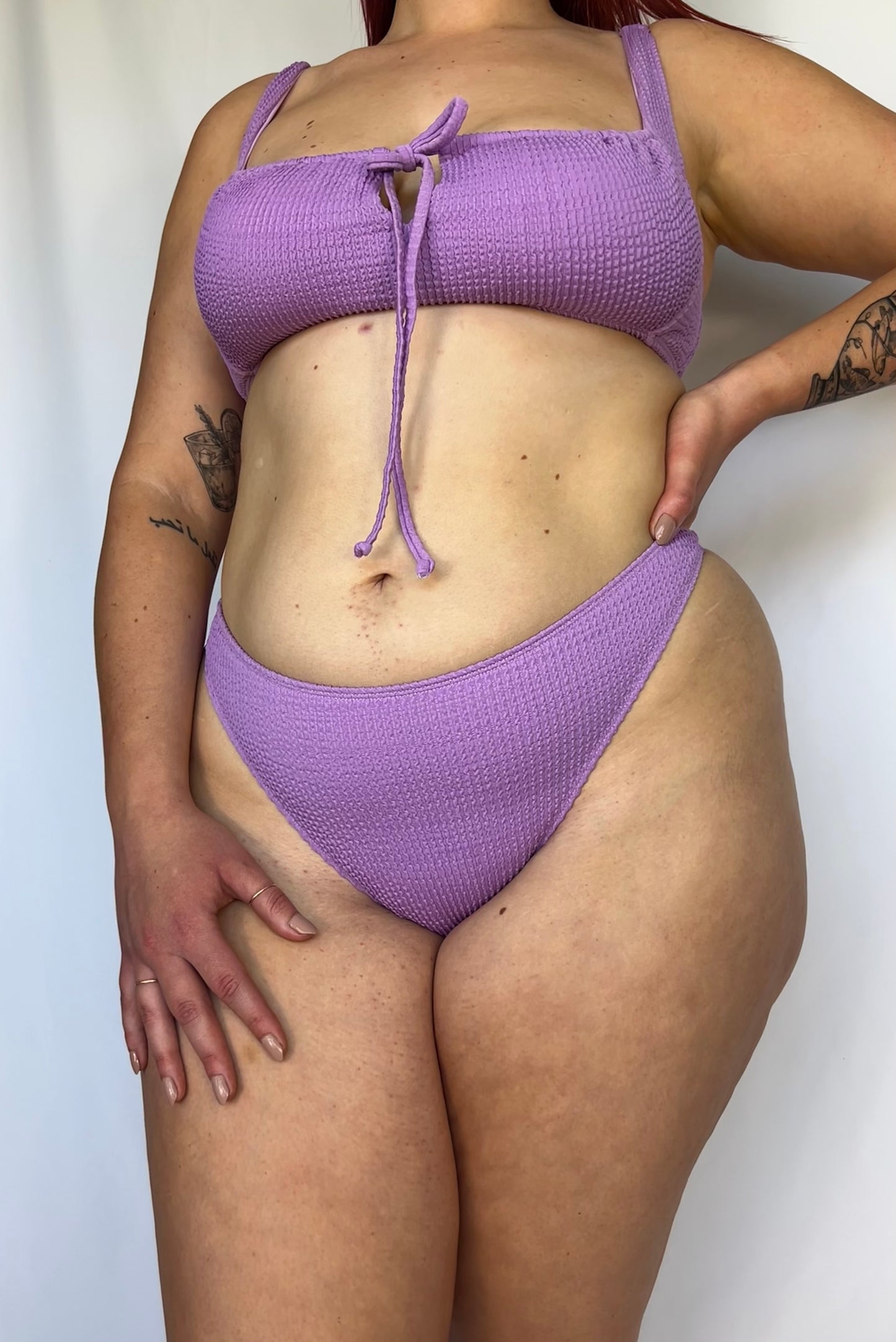 Close up of the lavender bikini bottom from the front. Model wears the high rise cheeky textured crinkle fabric bikini bottom.